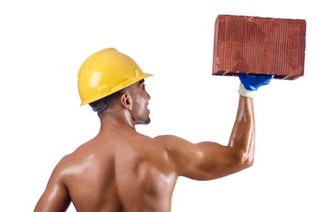 Muscular builder with bricks on whiteの写真素材