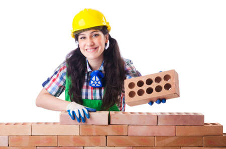 Woman builder with bricks on whiteの写真素材