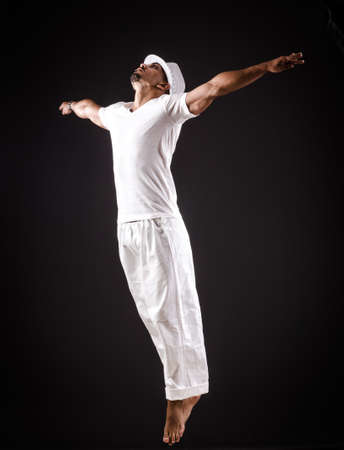 Dancer dancing dances in white clothing