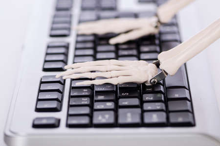 Skeleton working on the keyboardの写真素材