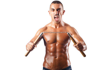 Man in martial arts concept with nunchucksの写真素材