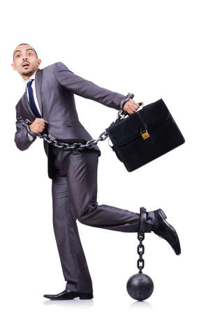 Businessman with shackles on whiteの写真素材