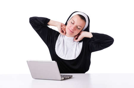 Nun working on laptop - religious conceptの写真素材