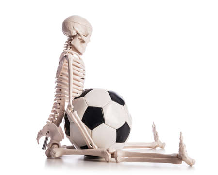 Skeleton with football isolated on the white