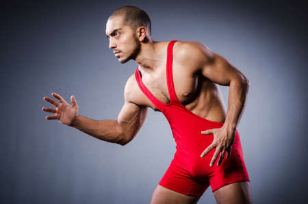 Young wrestler in dark studioの写真素材