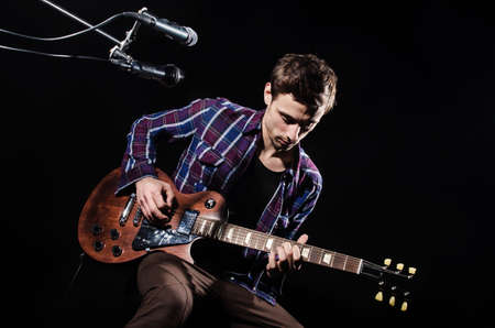 Man playing guitar during concert