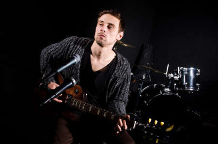 Man playing guitar during concertの写真素材