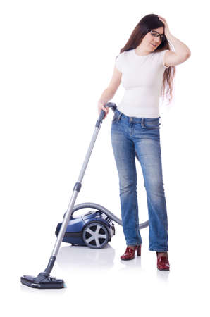 Young woman with vacuum cleaner on whiteの写真素材