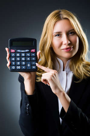 Businesswoman with calculator in business conceptの写真素材