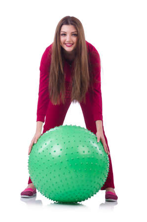 Young woman with ball exercising on whiteの写真素材