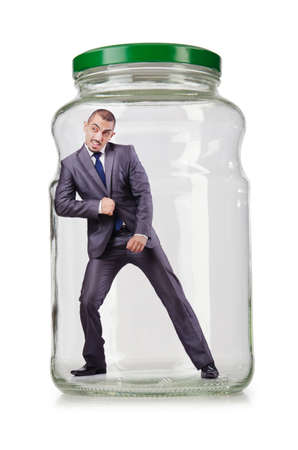 Young businessman in glass jarの写真素材