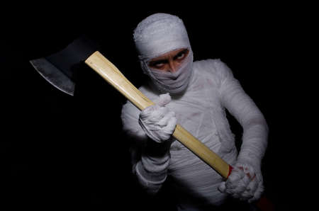 Mummy with axe in halloween conceptの写真素材