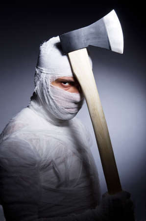 Mummy with axe in halloween conceptの写真素材