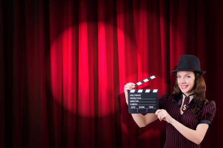 Woman gangster with movie clapper