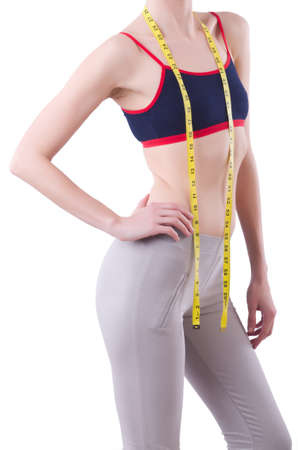 Young girl with centimeter in dieting conceptの写真素材
