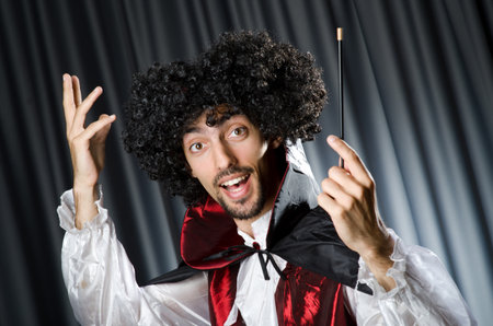 Magician in the dark room with wandの写真素材