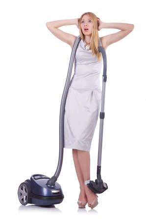 Young woman with vacuum cleaner on whiteの写真素材