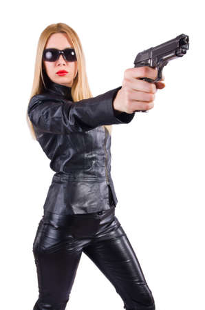 Woman with gun in black leather costumeの写真素材