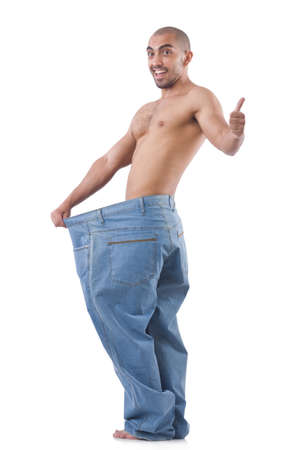 Man in dieting concept with oversized jeansの写真素材