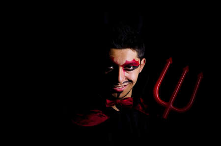 Man in devil costume in halloween concept