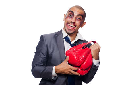 Badly beaten businessman with boxing glovesの写真素材