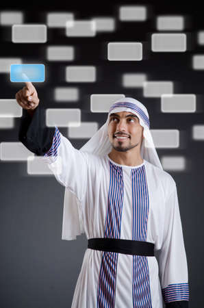 Arab businessman pressing virtual buttonsの写真素材