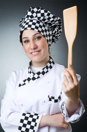 Pretty cook with kitchen utensilsの写真素材