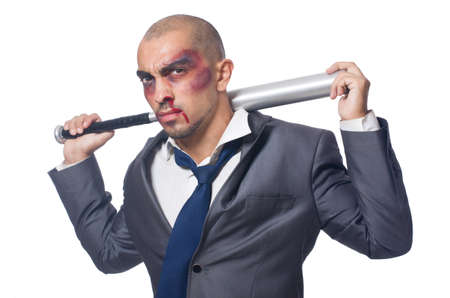 Badly bruised businessman with bat on whiteの写真素材