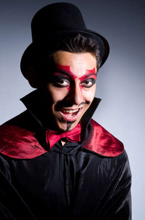 Man in devil costume in halloween conceptの写真素材
