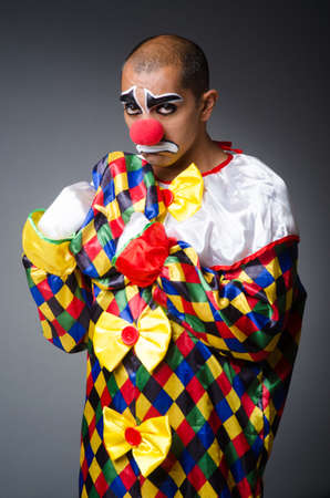 Sad clown against dark backgroundの写真素材