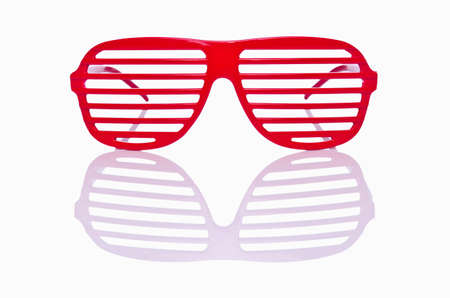 Red striped sunglasses isolated on whiteの写真素材
