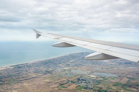 Airplane wing out of windowの写真素材