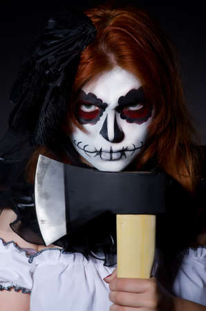 Woman monster with axe in dark roomの写真素材