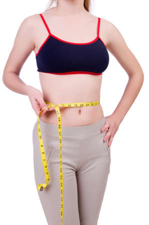 Young girl with centimeter in dieting conceptの写真素材