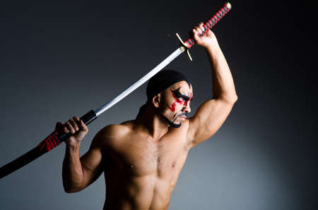 Man with sword and face paintの写真素材