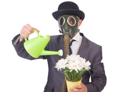 Businessman wearing gas mask isolated on whiteの写真素材