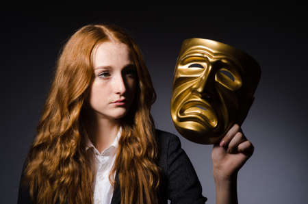 Woman with mask in hypocrisy conceptの写真素材