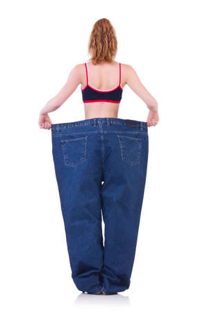 Woman with large jeans in dieting conceptの写真素材