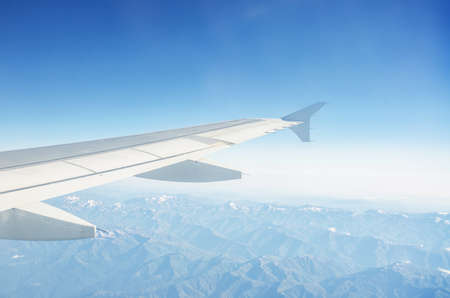 Airplane wing out of windowの写真素材