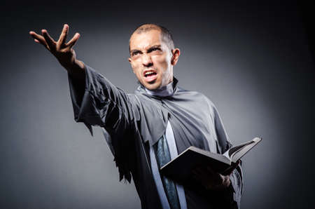 Young priest isolated on the white