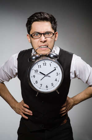 Businessman with clock in time conceptの写真素材