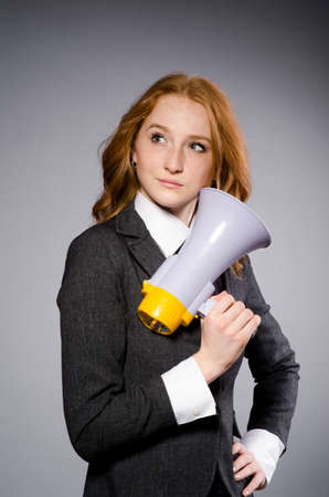 Woman with loudspeaker in studioの写真素材