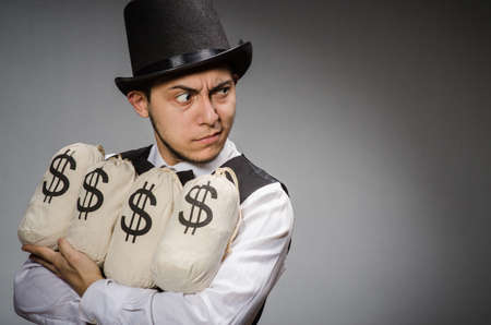 Man with sacks of moneyの写真素材
