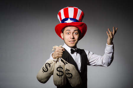 Funny man with american hat and sacks of money