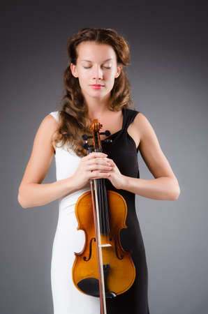 Woman artist with violin in music conceptの写真素材