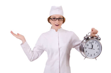 Attractive woman doctor with big clock  isolated on whiteの写真素材