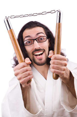 Karate man with nunchucks isolated on whiteの写真素材
