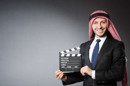  Arab man with movie clapper isolated on whiteの写真素材