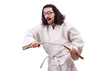 Karate man with nunchucks isolated on whiteの写真素材
