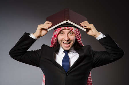 Arab man with book in diversity conceptの写真素材